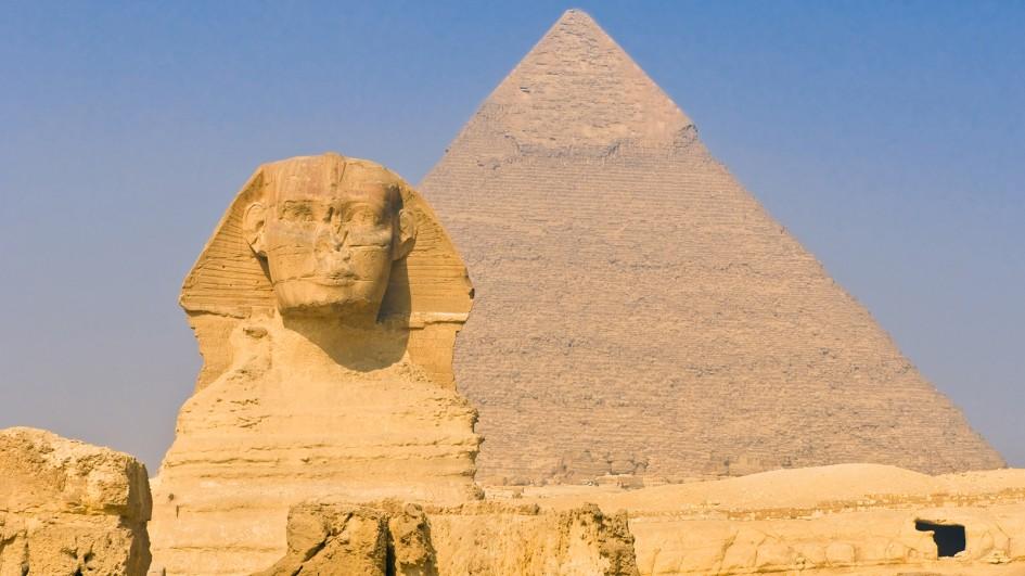 The Great Sphinx of Giza in front of a Pyramid